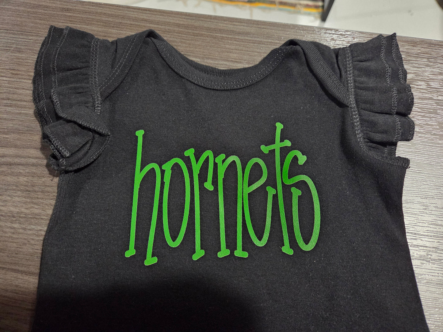 Blk Ruffled Hornets Onesie
